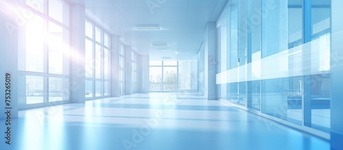 Medical blurred background in a light hospital hallway with a blue interior illustrating a clinical healthcare concept
