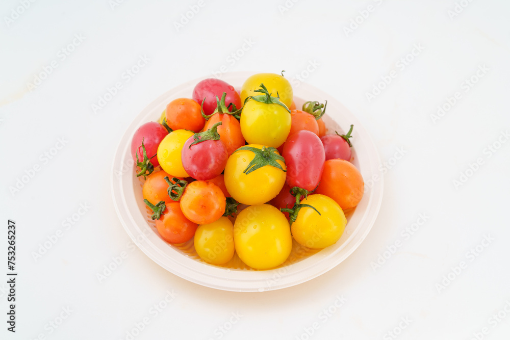 Fresh small persimmons of various colors on white background Fresh small persimmons of various colors on white background