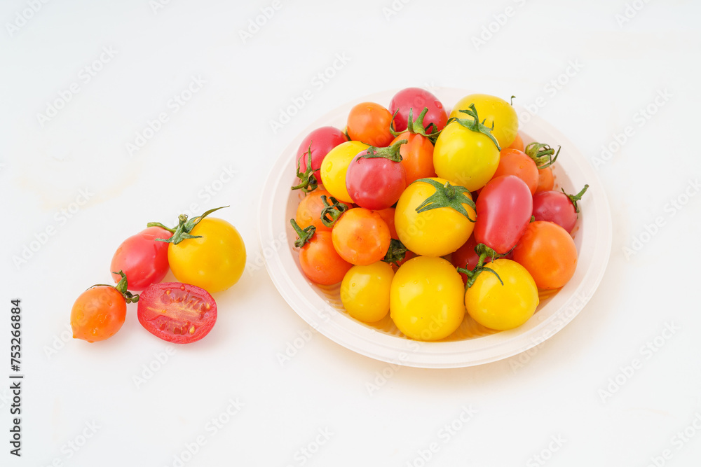Fresh small persimmons of various colors on white background Fresh small persimmons of various colors on white background