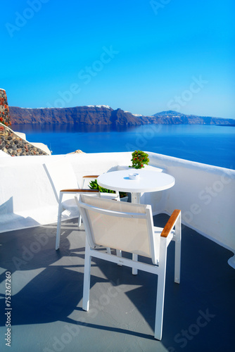 relaxing chairs and umbrella with view of caldera, Santorini, Greece © neirfy