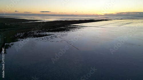 Wattenmeer in Friedrichskoog im Sonnenuntergang, Drohnenflug bei Abendstimmung photo