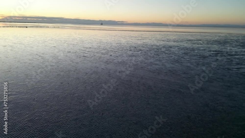 Wattenmeer in Friedrichskoog im Sonnenuntergang, Drohnenflug bei Abendstimmung photo