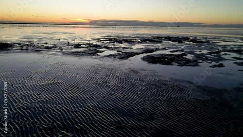 Wattenmeer in Friedrichskoog im Sonnenuntergang, Drohnenflug bei Abendstimmung photo