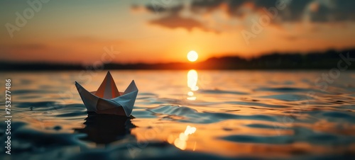 toy paper boat in the water during sunset © Ibad