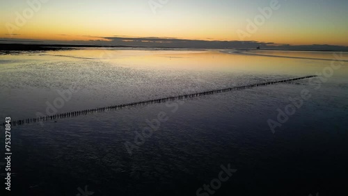 Wattenmeer in Friedrichskoog im Sonnenuntergang, Drohnenflug bei Abendstimmung photo