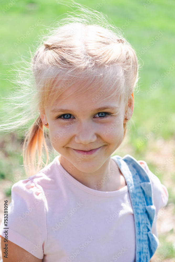 A joyful young girl smiles outdoors, embodying childhood happiness, healthy living, and the vitality of nature in her sunny, grassy backdrop. A joyful young girl smiles outdoors, embodying childhood happiness, healthy living, and the vitality of nature in her sunny, grassy backdrop.