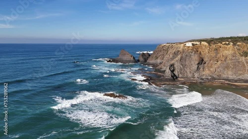 Ocean waves crashing on the rocks. Odeceixe Mar Beach, Portugal