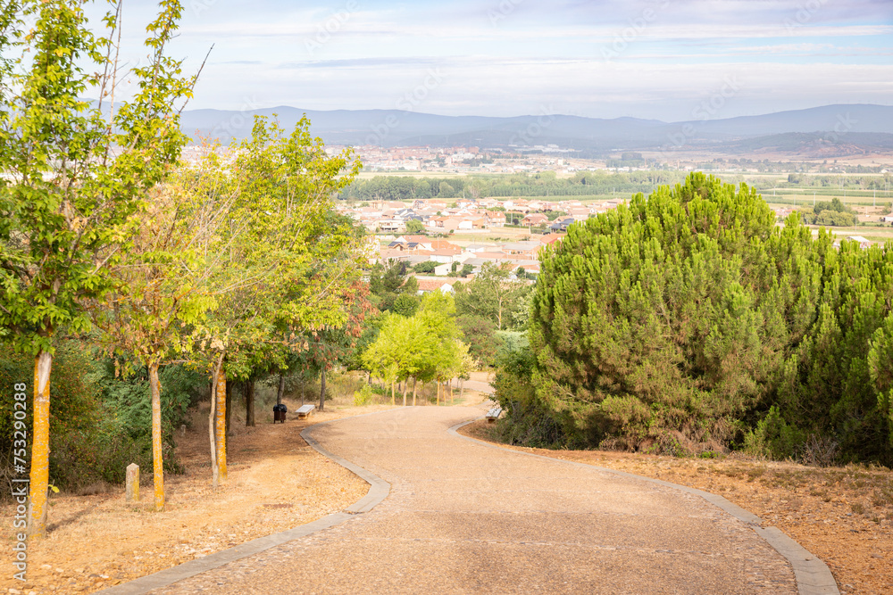 French Way of Saint James - a paved road with a view over San Justo de la Vega and Astorga, province of León, Castile and Leon, Spain