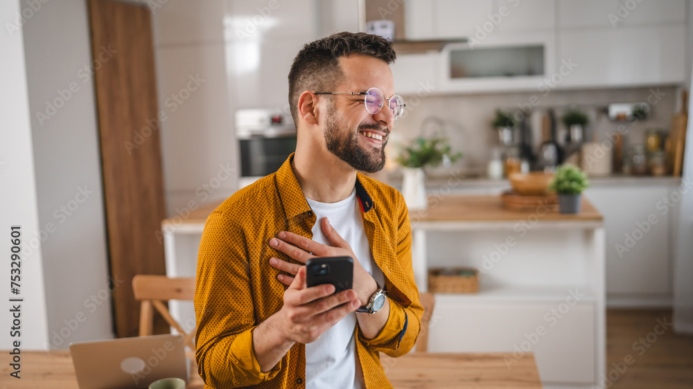 man with eyeglasses stand at home use mobile phone sms texting man with eyeglasses stand at home use mobile phone sms texting