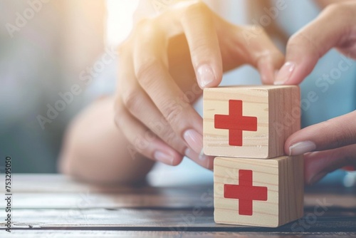 Health insurance concept. people hands putting plus symbol and healthcare medical wooden cube block with icon, health and access to welfare health. photo