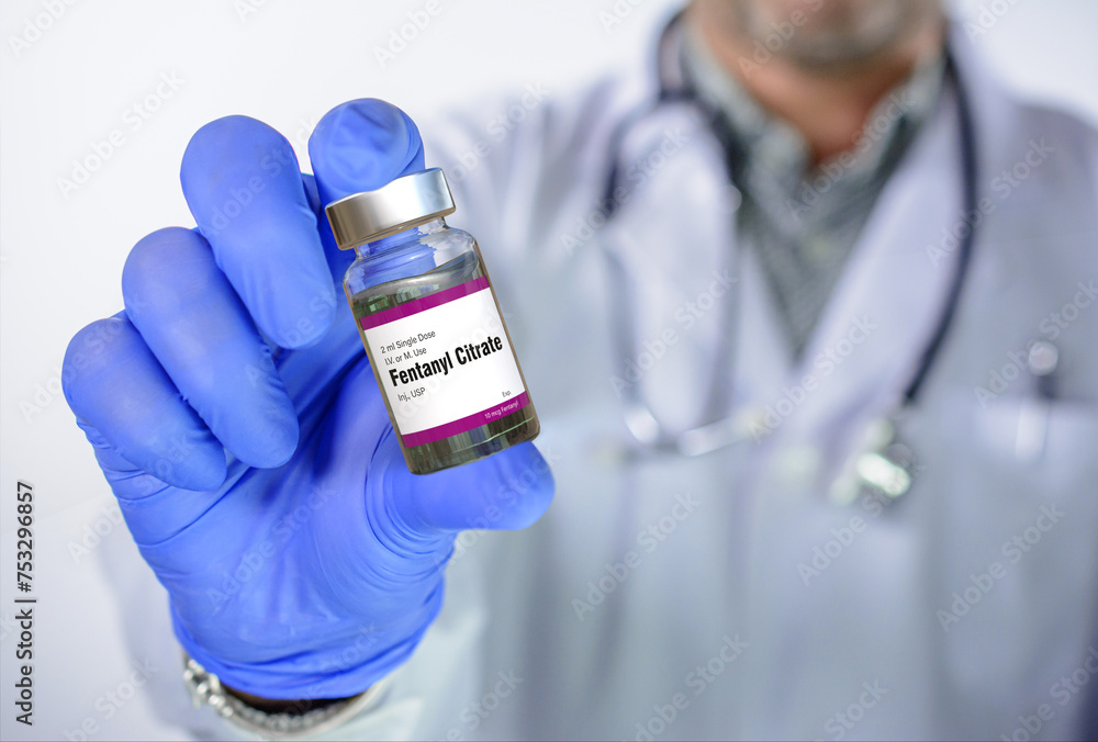 Doctor has Fentanyl ampoule in hand. Fentanyl is an opioid used as pain medication and for anesthesia. It is also used as a recreational drug mixed with heroin or cocaine. Doctor has Fentanyl ampoule in hand. Fentanyl is an opioid used as pain medication and for anesthesia. It is also used as a recreational drug mixed with heroin or cocaine.