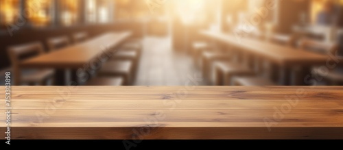 Wooden table in a blurred restaurant interior with space for decoration or product display