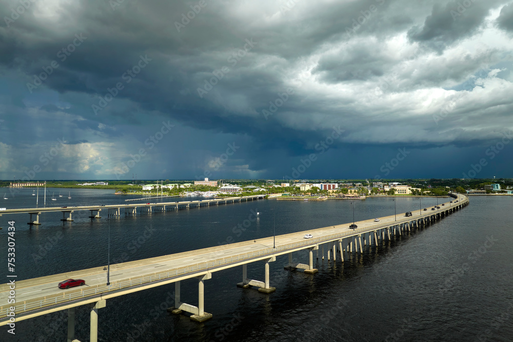 Fototapeta premium Barron Collier Bridge and Gilchrist Bridge in Florida with moving traffic. Transportation infrastructure in Charlotte County connecting Punta Gorda and Port Charlotte over Peace River