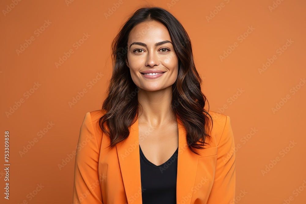 Portrait of a smiling business woman in orange jacket over orange background Portrait of a smiling business woman in orange jacket over orange background