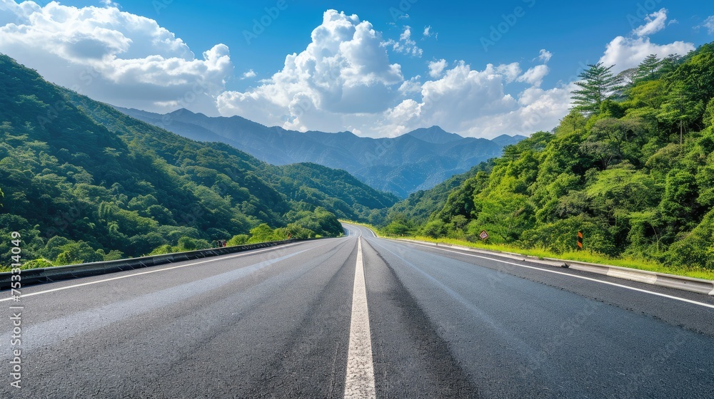 
Asphalt highway road and green forest with mountain natural landscape under blue sky, nature background