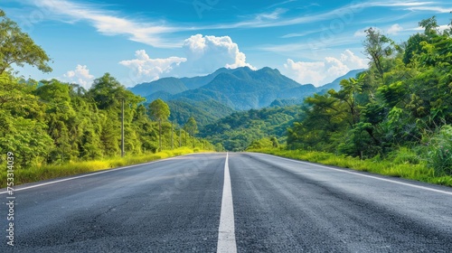 
Asphalt highway road and green forest with mountain natural landscape under blue sky, nature background