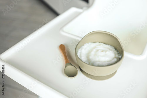 Rice porridge for children in a plate. Feeding children healthy porridge