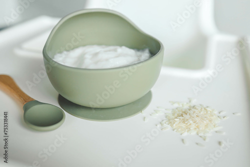 Rice porridge for children in a plate. Feeding children healthy porridge