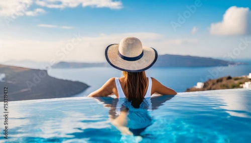 Beautiful women on vacation at Santorini relaxing in swimming pool looking out over ocean.  © adobedesigner