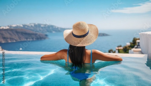 Beautiful women on vacation at Santorini relaxing in swimming pool looking out over ocean. © adobedesigner