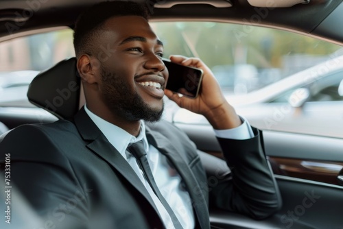 Happy man talking on mobile in car. © InfiniteStudio