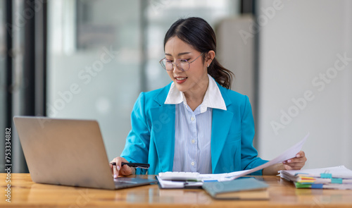 Business Documents, Auditor businesswoman checking searching document legal prepare paperwork or report for analysis TAX time,accountant Documents data contract partner deal in workplace office  © David