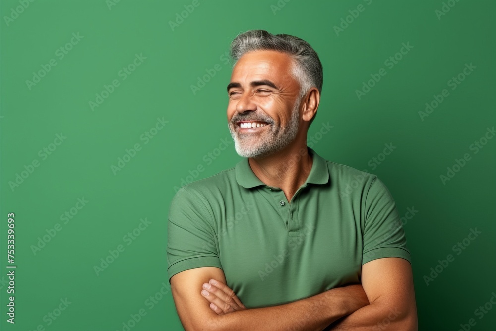 Portrait of a smiling senior man in green t-shirt against green background Portrait of a smiling senior man in green t-shirt against green background