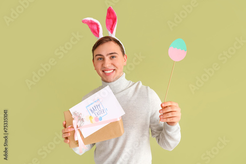 Smiling young man in bunny ...