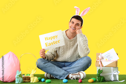 Happy young man in bunny ea...