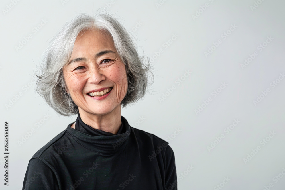 Portrait of old healthy, cheerful beautiful Asian woman smiling and looking at camera with white background. Happy aging society, retirement and senior healthcare concept Portrait of old healthy, cheerful beautiful Asian woman smiling and looking at camera with white background. Happy aging society, retirement and senior healthcare concept