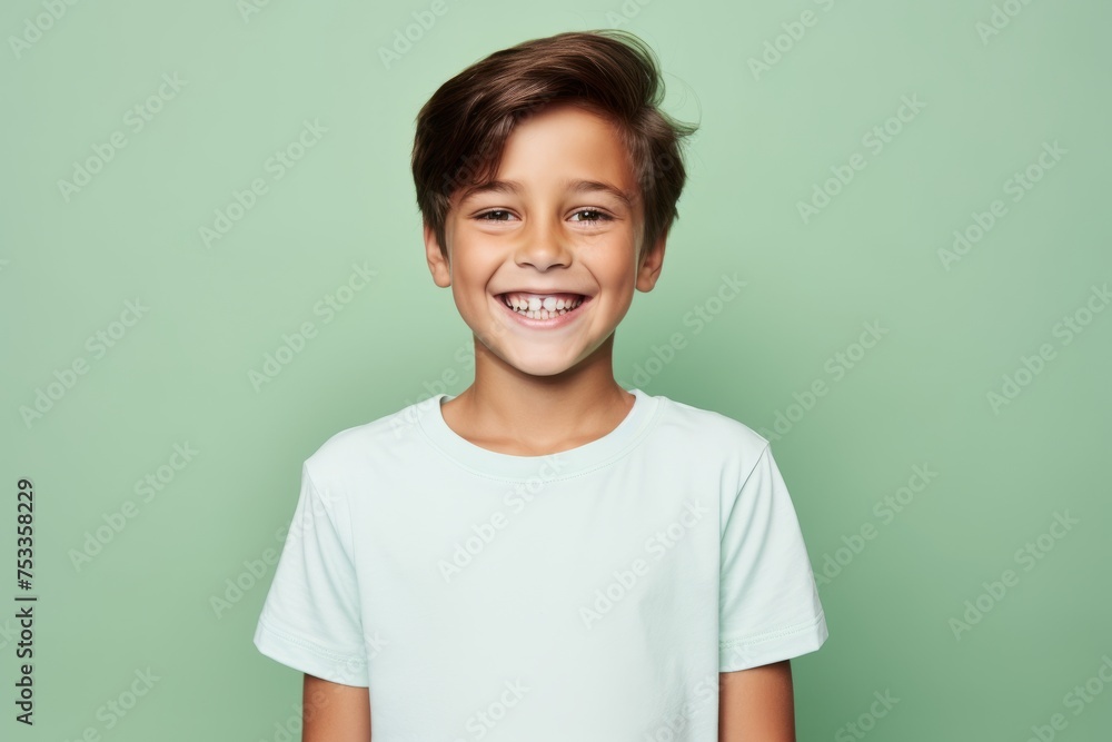 Portrait of a cute little boy in a white t-shirt on a green background Portrait of a cute little boy in a white t-shirt on a green background
