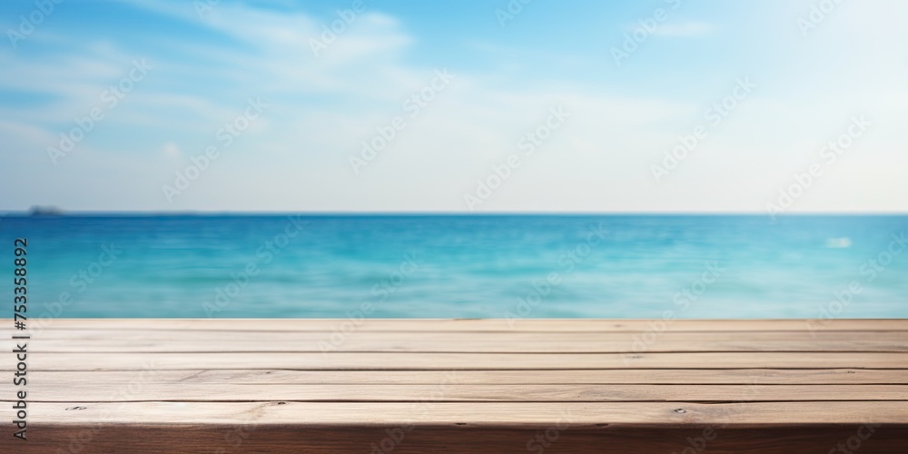 Blurred summer blue sea and sky background with wooden table top.