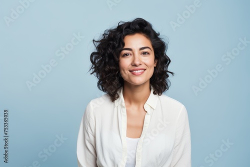 Portrait of happy smiling beautiful young businesswoman, over blue background