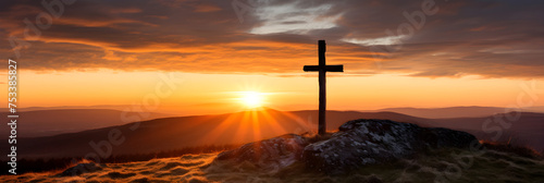 Divine Silence: A Weathered Wooden Cross Silhouetted Against a Stunning Sunset Over a Tranquil Landscape