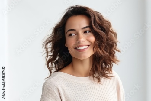 Portrait of a beautiful young woman with long brown curly hair.