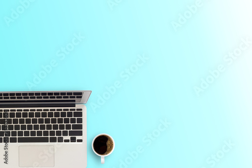 Office desk or workspace with laptop computer and coffee cup with copy space