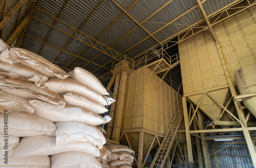 Chicken feed ingredients bags stacked in poultry feed mill plant.