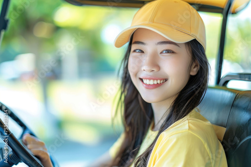 Beautiful asian cheerful woman sitting in golf cart