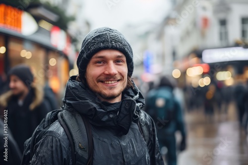 Portrait of a young man in winter clothes on a city street