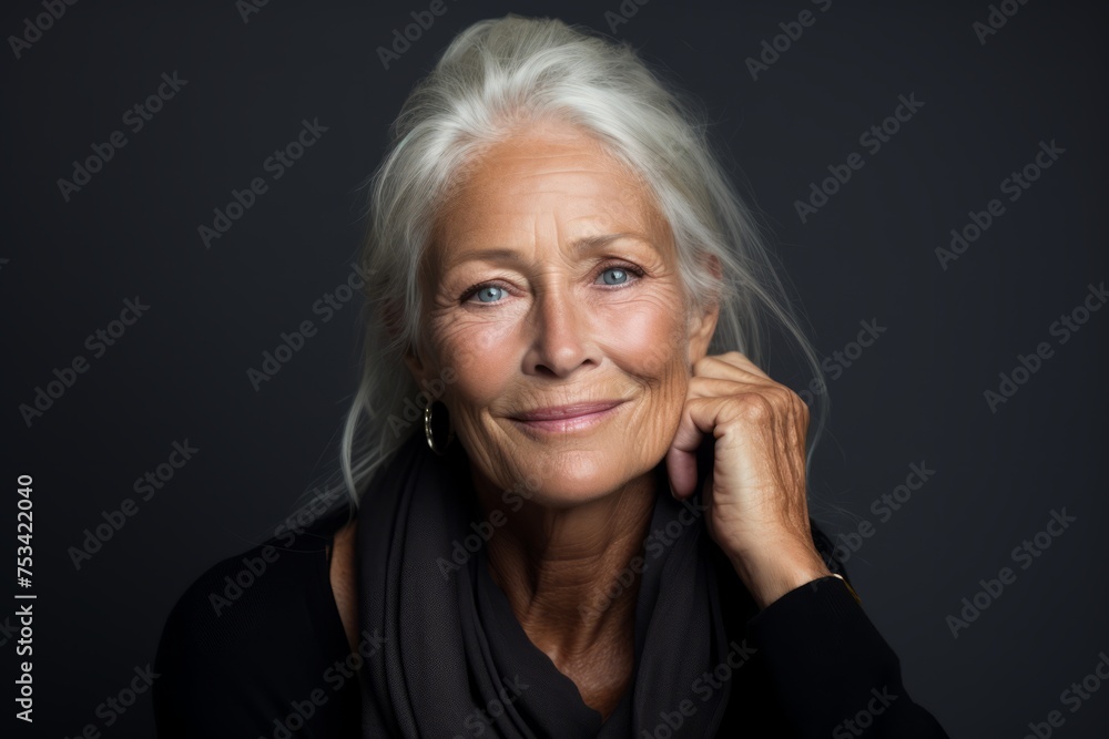 Portrait of a beautiful senior woman with grey hair on dark background Portrait of a beautiful senior woman with grey hair on dark background