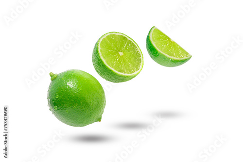 Flying green lime with slices and shadow isolated on white background.