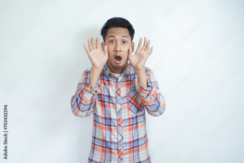 Adult Asian man looking camera with shocked expression Adult Asian man looking camera with shocked expression