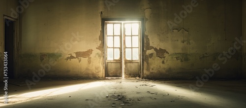 Abandoned building interior with double doors and dim natural lighting