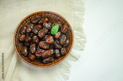 Dried dates in a ceramic plate, top view photo