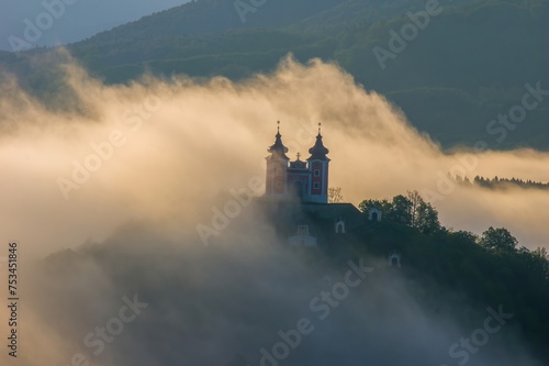 Amazing natural scenery with fog and a historical building obscured in the fog. Beautiful natural view  wet weather