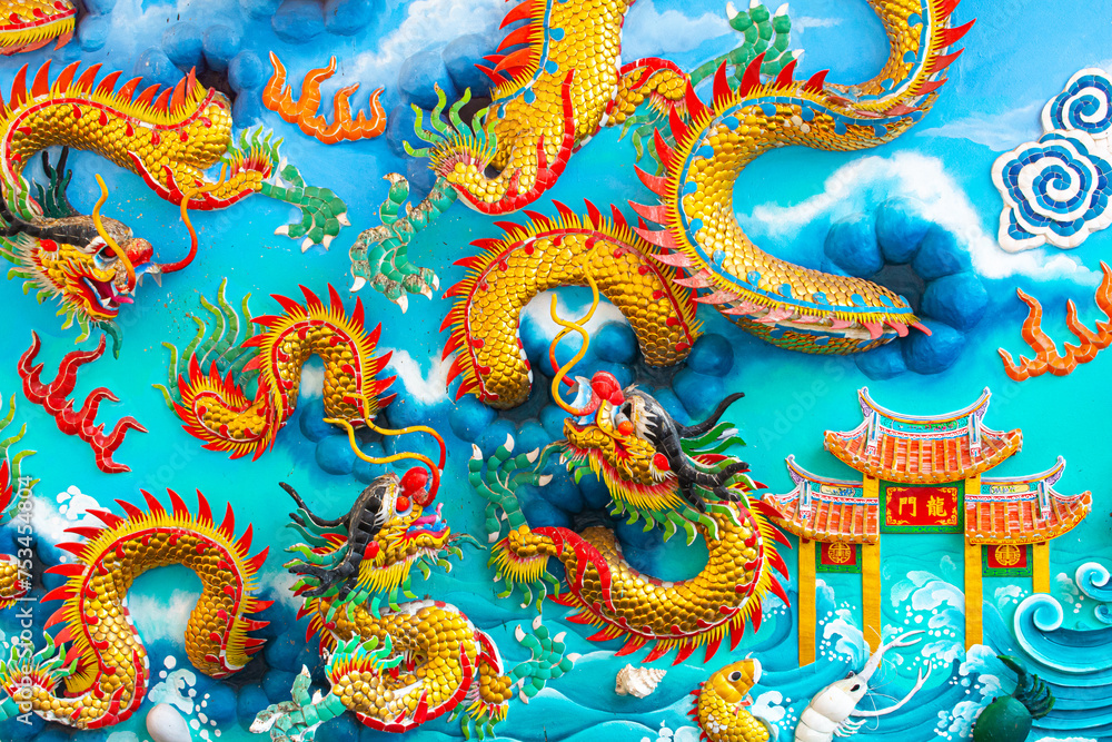 The chinese dragon statue on the wall.