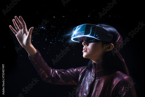 Beautiful girl in virtual reality glasses touches the air with her hand