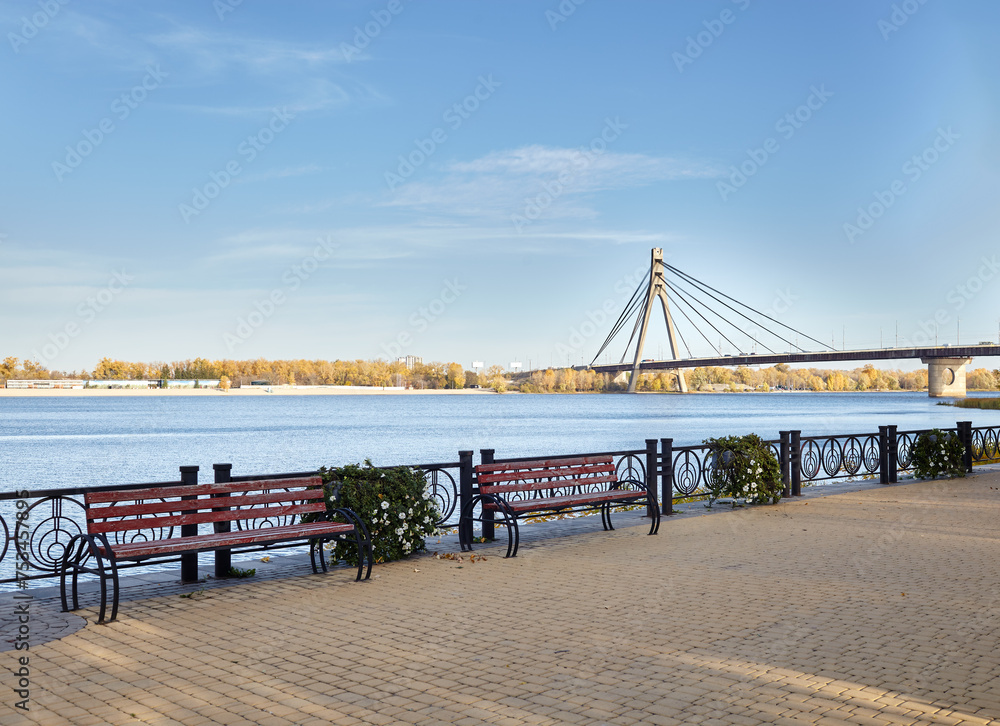 Rest area with benches on the river embankment in Kyiv, Europe. Place to rest in the city park