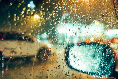 Rainny mood shade of light drop water rain background on car mirror vision.