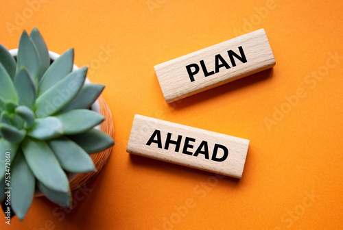 Plan ahead symbol. Wooden blocks with words Plan ahead. Beautiful orange background with succulent plant. Business and Plan ahead concept. Copy space.
